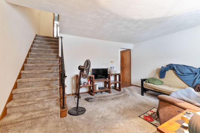 living room featuring a textured ceiling and carpet flooring