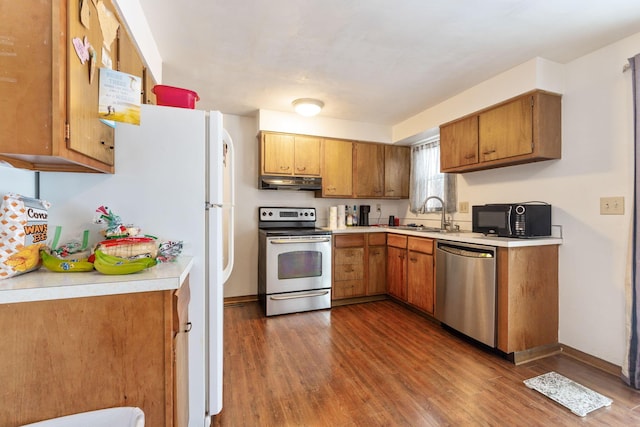 kitchen featuring dark wood-type flooring, sink, and appliances with stainless steel finishes