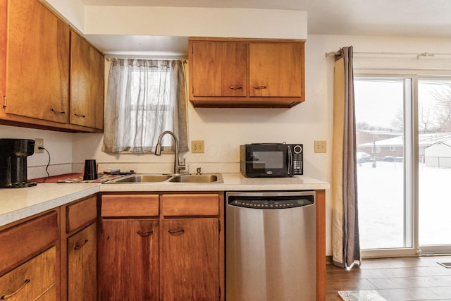 kitchen featuring dishwasher, dark hardwood / wood-style floors, and sink