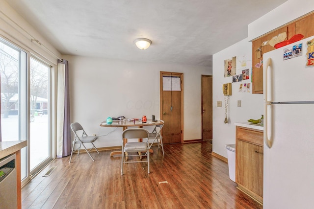 dining space with dark hardwood / wood-style floors