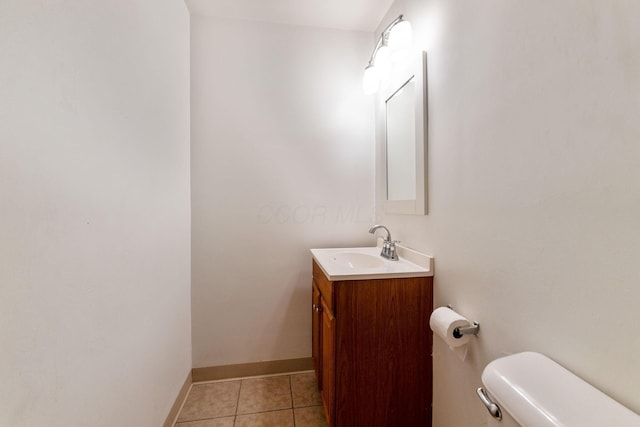 bathroom featuring toilet, tile patterned flooring, and vanity