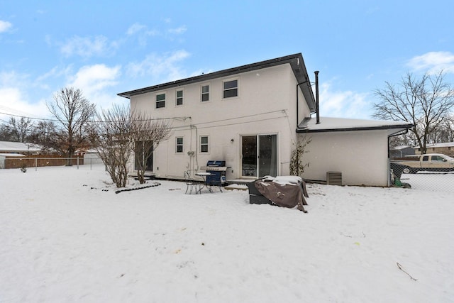 view of snow covered rear of property