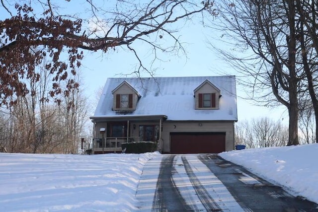 cape cod-style house featuring covered porch and a garage