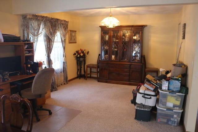 carpeted office space with an inviting chandelier