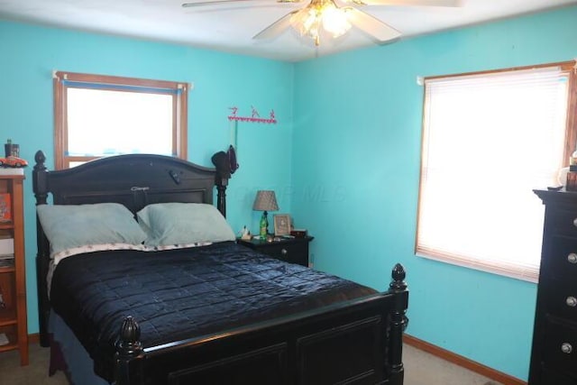 bedroom with ceiling fan and light colored carpet