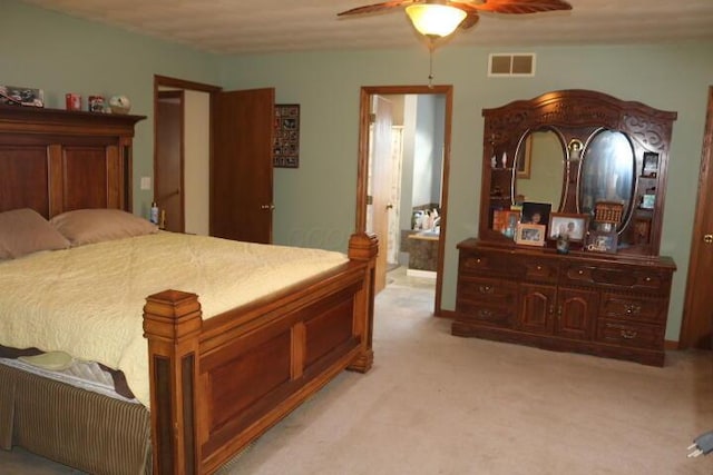 carpeted bedroom with ceiling fan and connected bathroom