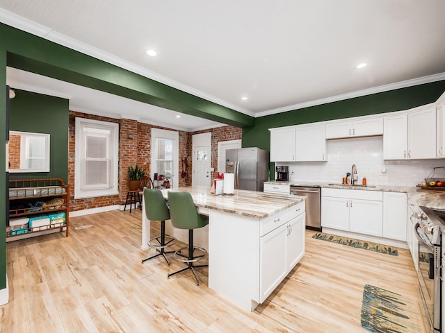 kitchen featuring white cabinets, a center island, and appliances with stainless steel finishes