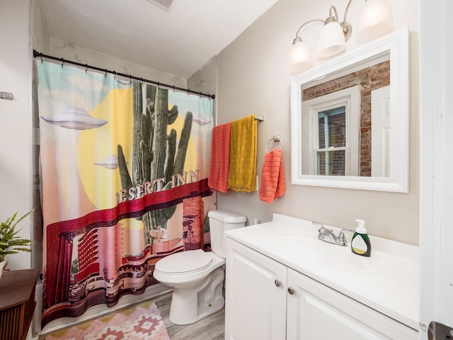 bathroom featuring vanity, hardwood / wood-style flooring, a shower with curtain, and toilet