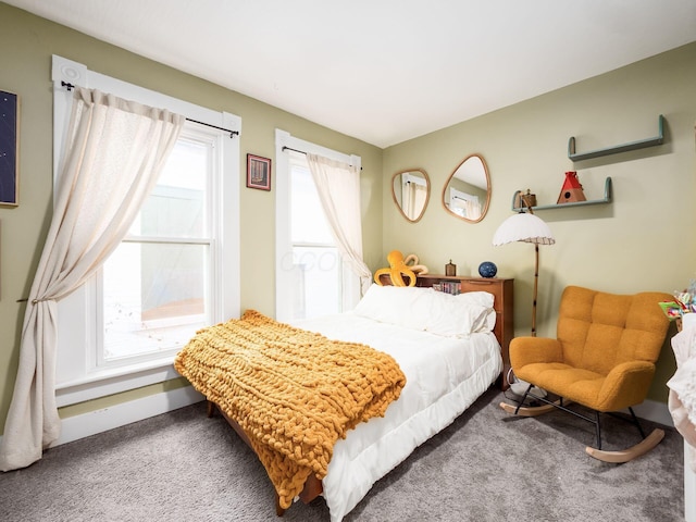 carpeted bedroom with multiple windows