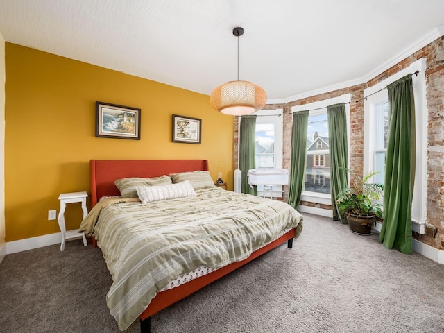 carpeted bedroom featuring brick wall