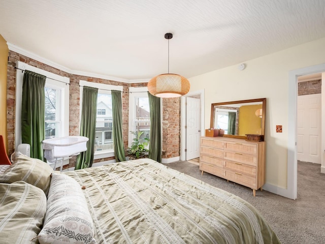 bedroom featuring brick wall and carpet flooring