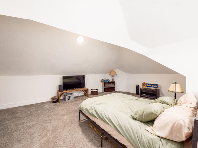 bedroom with carpet floors and vaulted ceiling