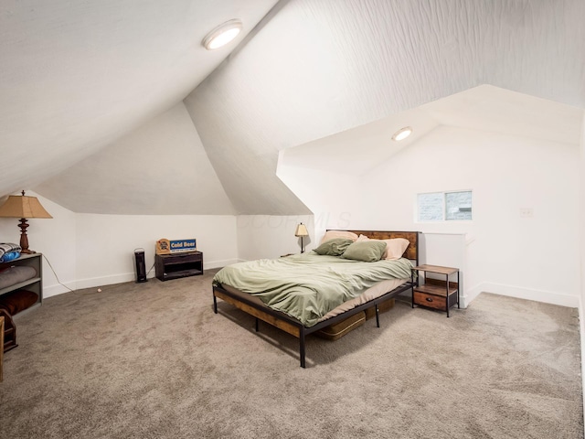 carpeted bedroom with lofted ceiling