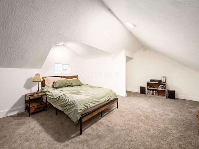 carpeted bedroom with vaulted ceiling