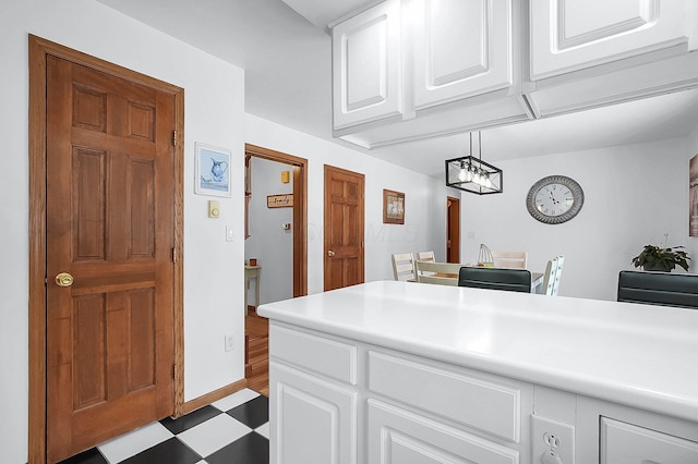 kitchen with white cabinets and pendant lighting