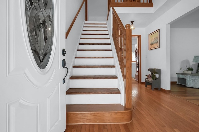 stairway with hardwood / wood-style flooring