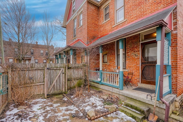 snow covered patio with covered porch