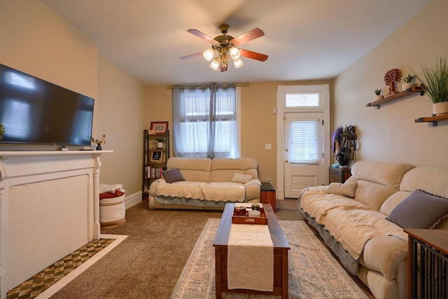 carpeted living room with ceiling fan