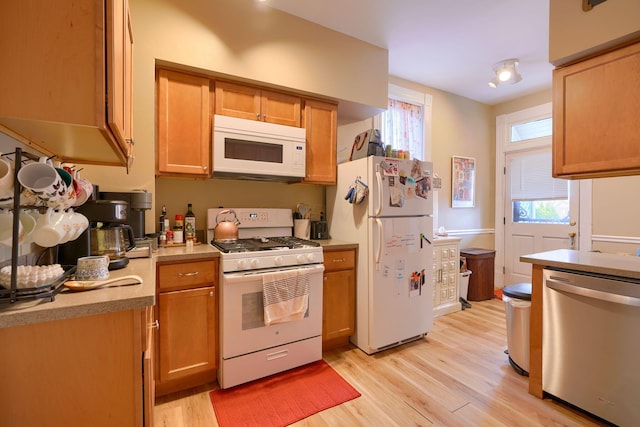 kitchen with light wood-type flooring and white appliances