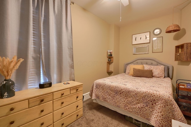 bedroom with ceiling fan and dark colored carpet