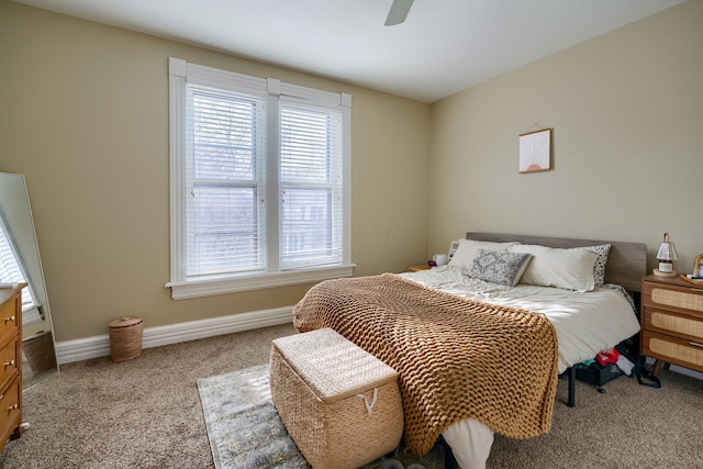 bedroom with ceiling fan and light carpet