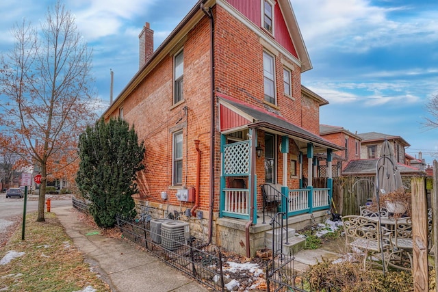 view of home's exterior featuring central AC and covered porch