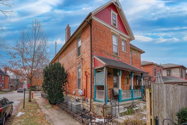 view of home's exterior featuring cooling unit and covered porch