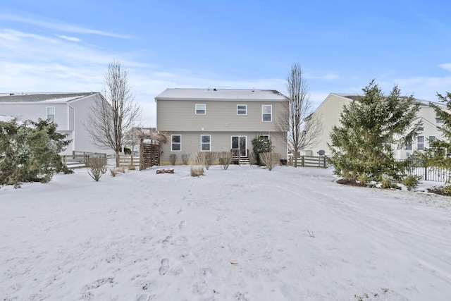 view of snow covered back of property