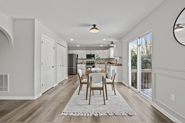 dining room featuring light wood-type flooring