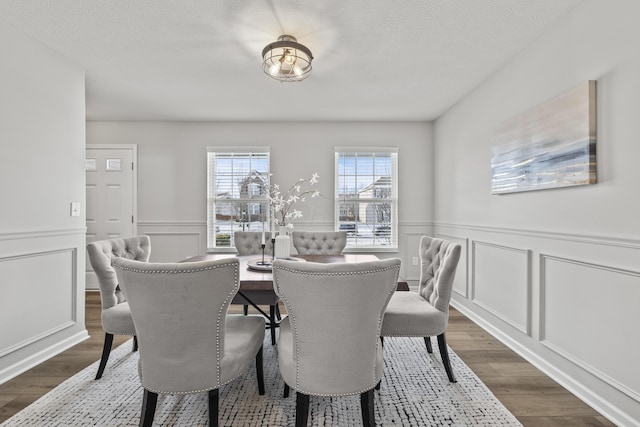 dining area featuring dark hardwood / wood-style floors and a textured ceiling