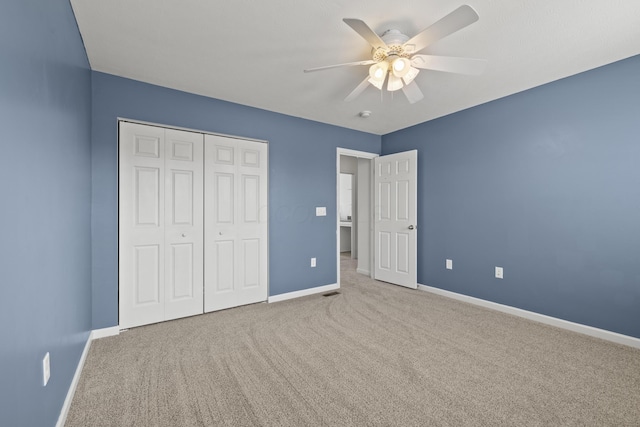 unfurnished bedroom with a closet, ceiling fan, and carpet