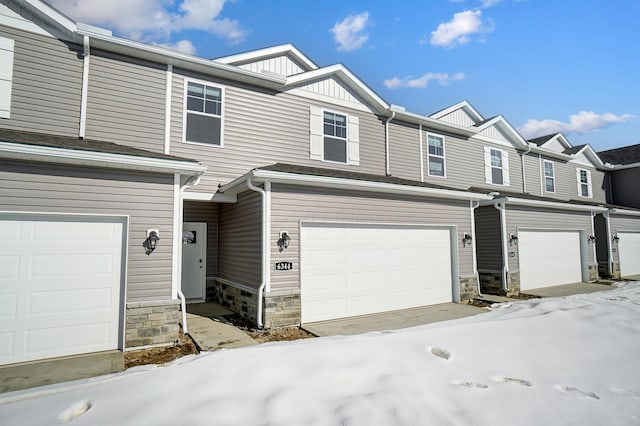 townhome / multi-family property featuring a garage