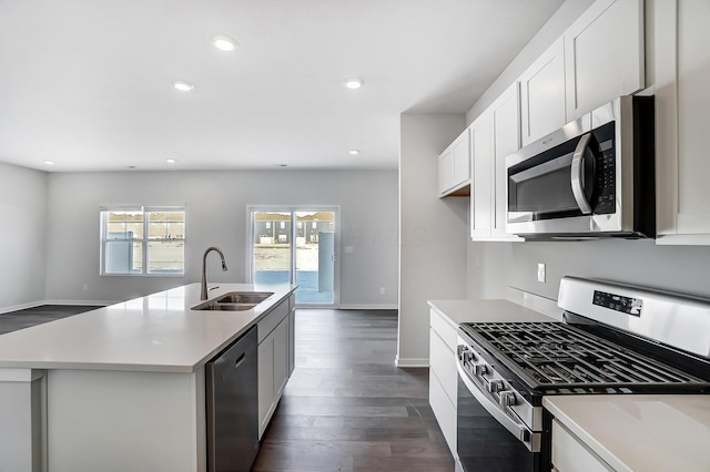 kitchen featuring dark wood-type flooring, recessed lighting, appliances with stainless steel finishes, and a sink