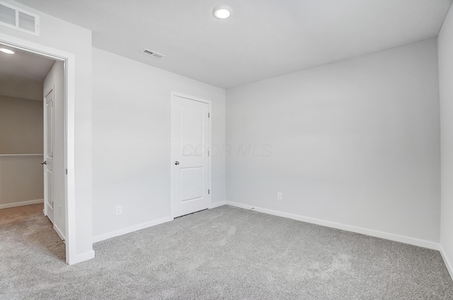 unfurnished bedroom featuring carpet flooring, baseboards, and visible vents