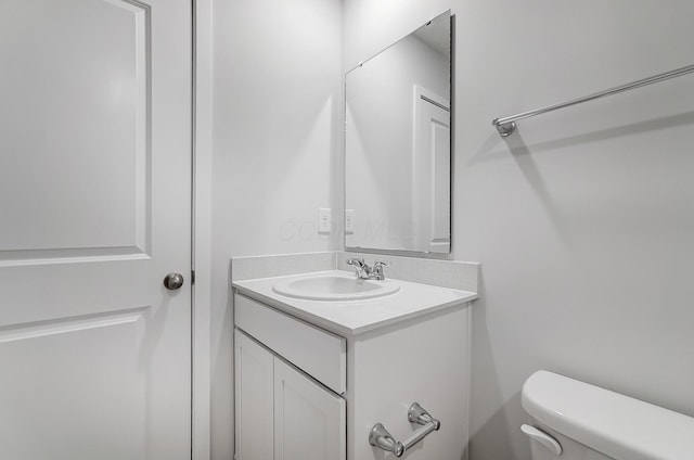 bathroom featuring toilet and vanity