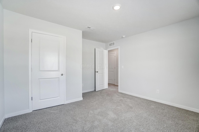 unfurnished bedroom with visible vents, baseboards, and carpet flooring