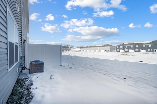 view of yard featuring a residential view and central AC unit