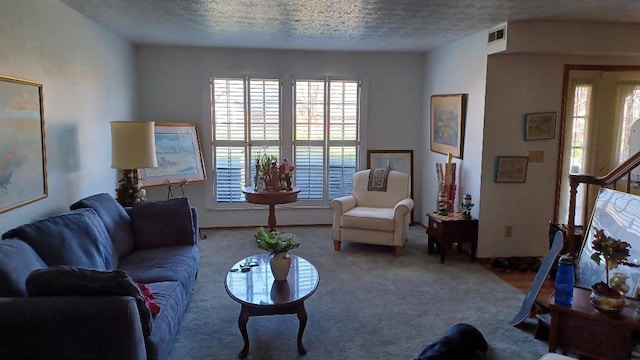 living room featuring carpet flooring and a textured ceiling