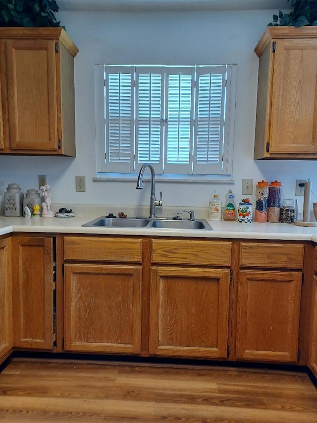 kitchen with a wealth of natural light, sink, and light hardwood / wood-style floors