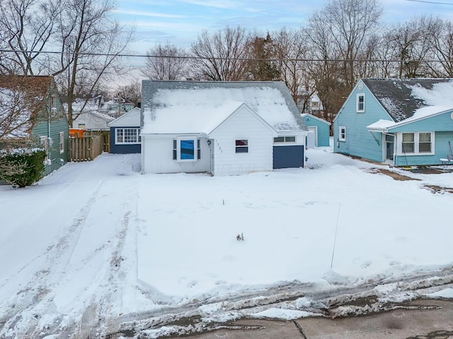 view of snow covered back of property