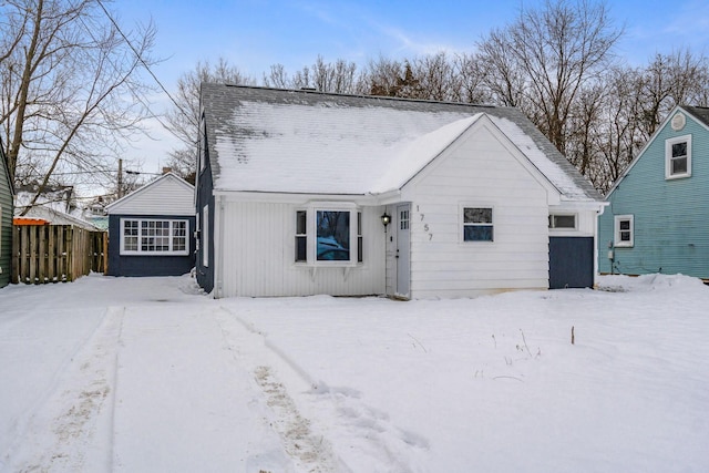 view of snow covered rear of property