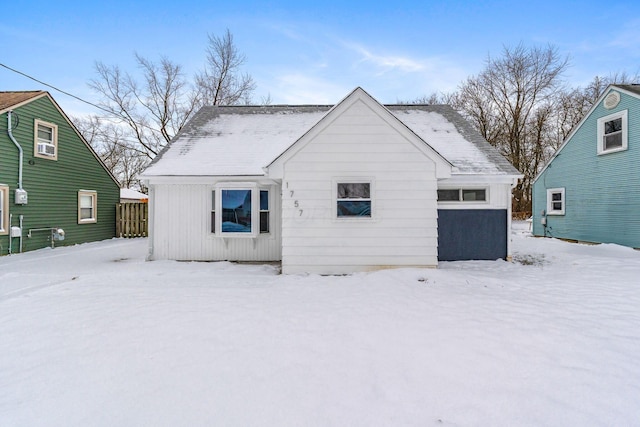 view of snow covered back of property