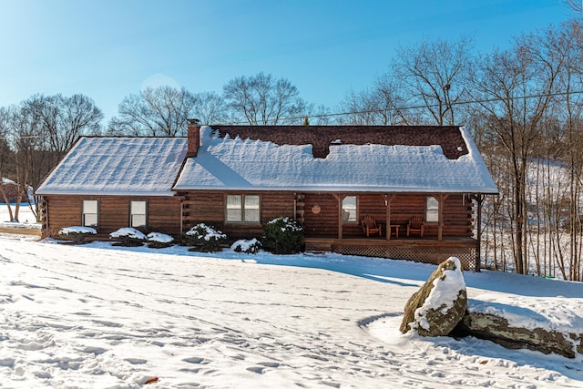 snow covered property featuring a porch