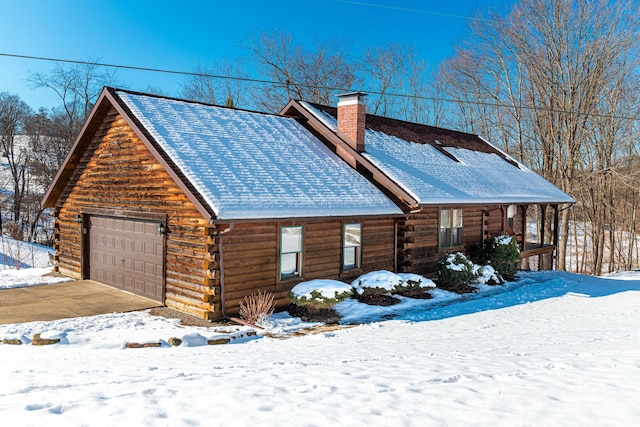 snow covered property featuring a garage