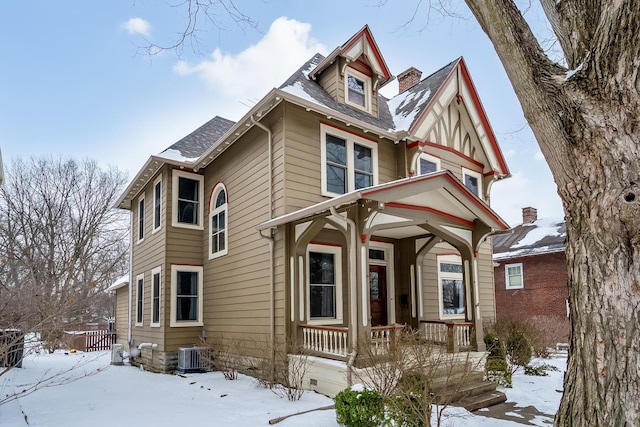 victorian-style house featuring covered porch and central air condition unit