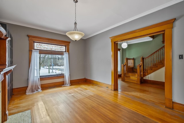 unfurnished dining area featuring light hardwood / wood-style flooring and ornamental molding