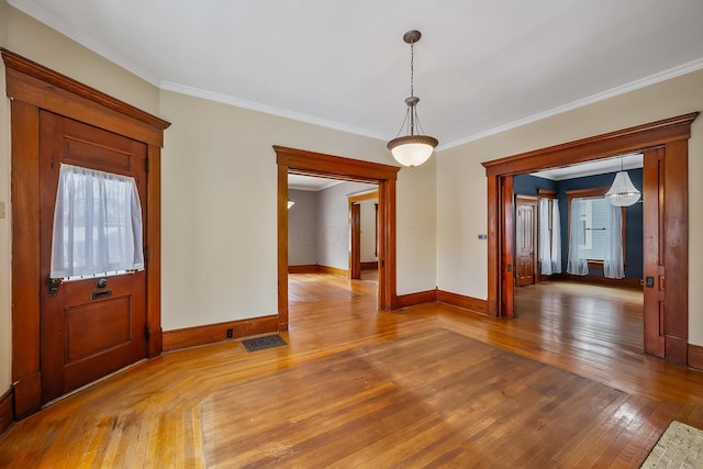 unfurnished room featuring hardwood / wood-style flooring and crown molding