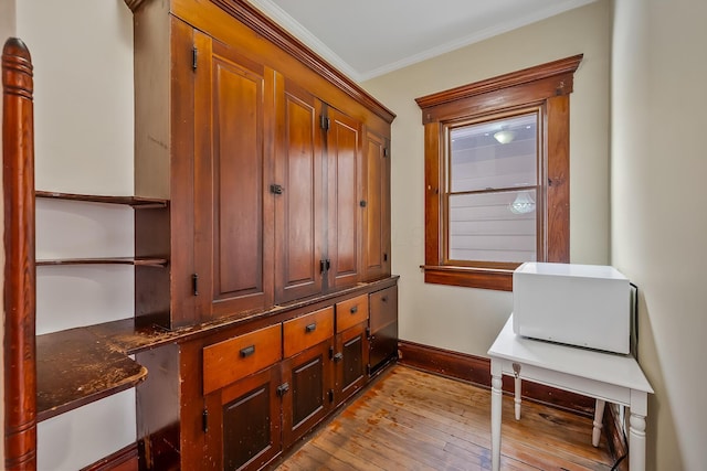 interior space featuring light hardwood / wood-style flooring and ornamental molding