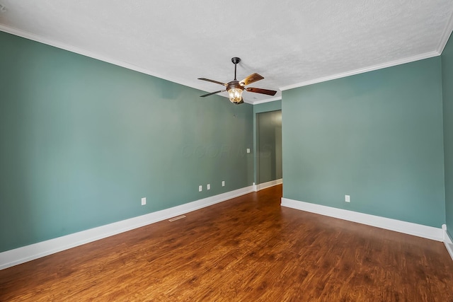 spare room featuring a textured ceiling, dark hardwood / wood-style flooring, ceiling fan, and crown molding