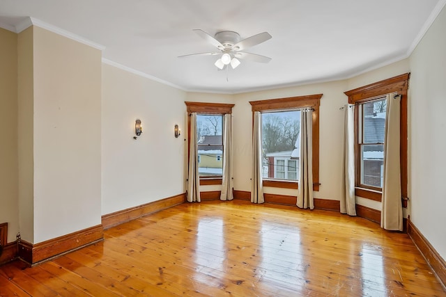 empty room featuring light wood-type flooring and crown molding